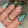 Long Stiletto Green French Tip Nails and Golden Charms
