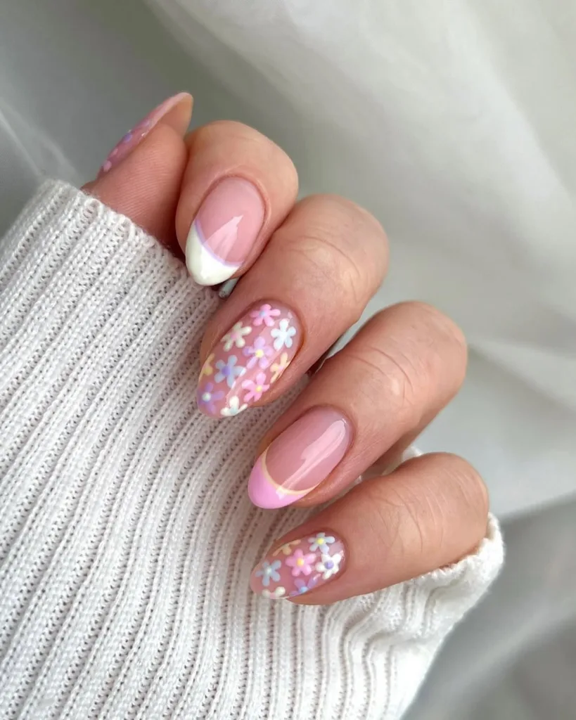 Classic French nails with pastel pink and floral confetti.