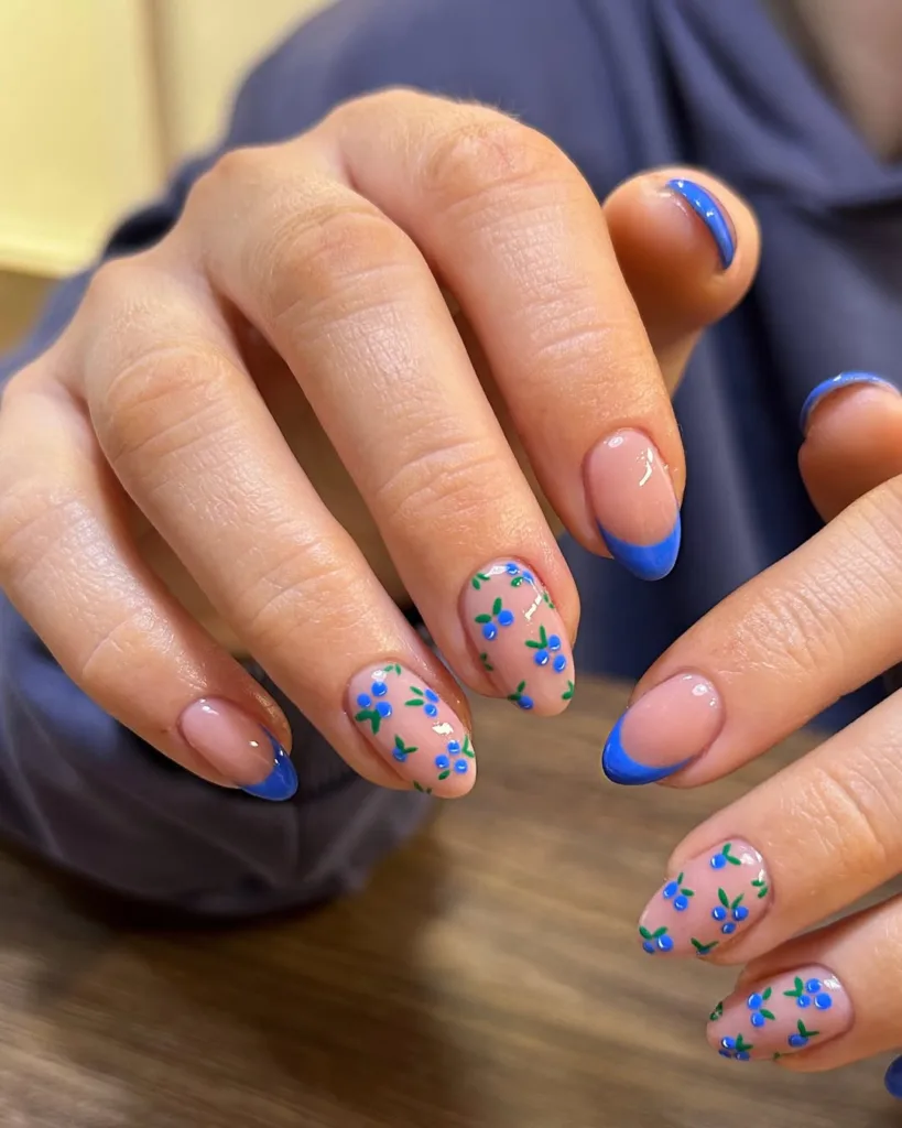Bright blue French tips with delicate floral details.