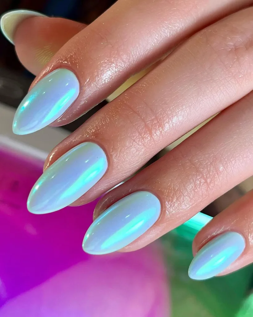 Opalescent nails with shifting blue-green color reflections.