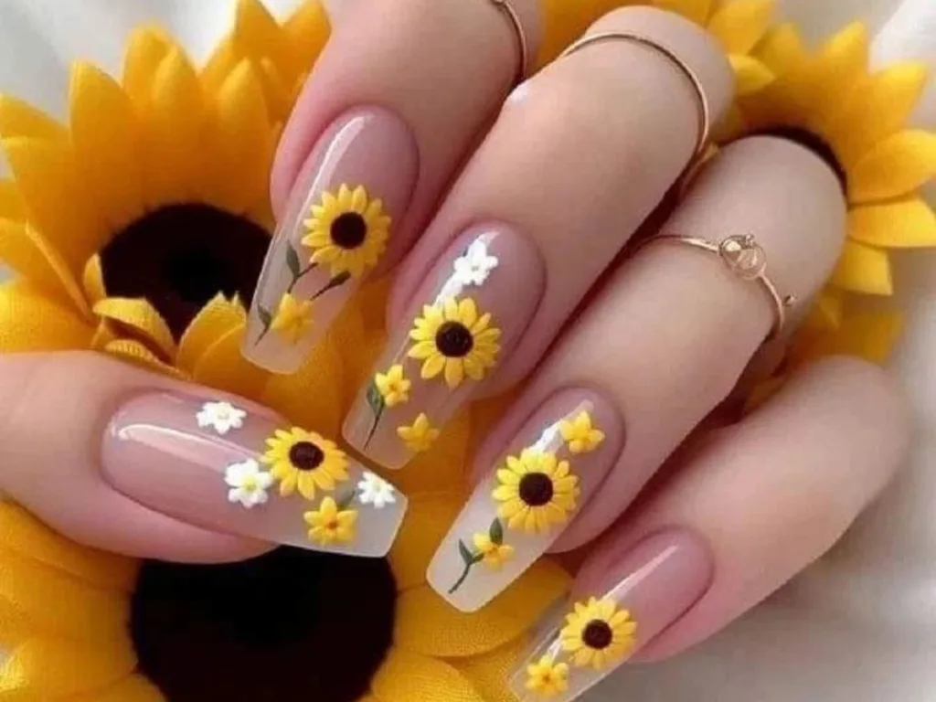 Square nails featuring sunflowers and daisies on a soft, translucent base.