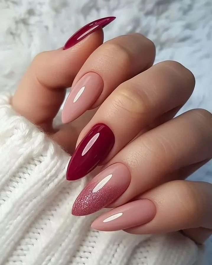 Almond nails with nude pink and deep burgundy contrast.