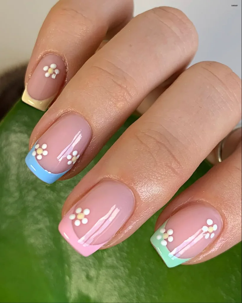 Square pastel French tip nails with mini flowers, cute and classic for spring.