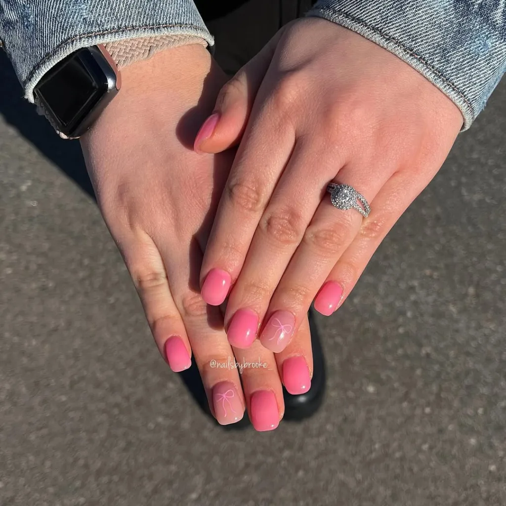 Ombre pink nails with bow designs, perfect for spring picnics and brunches.