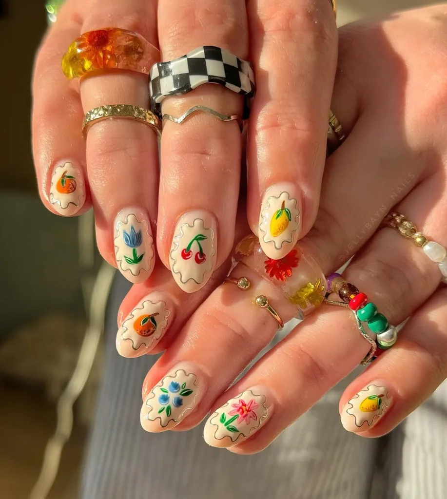  Almond jelly white nails with colorful Y2K floral and fruit designs, perfect for spring 2025.